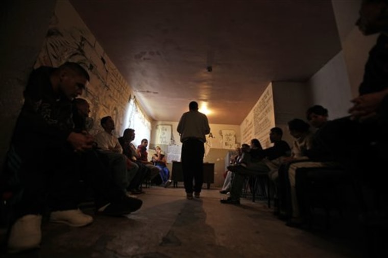 In this Nov.  20, 2009 photo, drug addicts attend to a group session at the CDLDA rehab center in Ciudad Juarez, Mexico. Mexico's powerful drug cartels have been operating drug rehabilitation clinics, turning some into bloody killing fields and forcing recovering addicts into their ranks of hit men and smugglers. (AP Photo/Guillermo Arias)